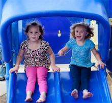 two children playing on an age appropriate playground