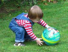 Spatially aware child playing with ball