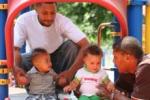 two children and their parents using directional awareness as they use slide at the playground